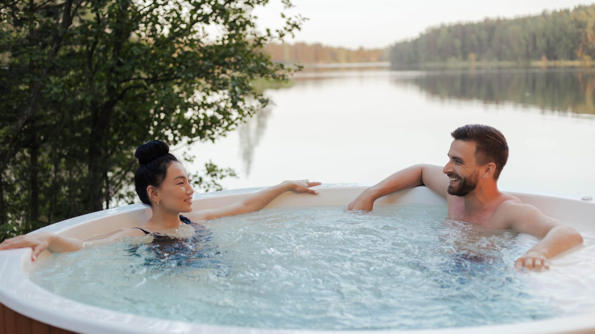 Couple Relaxing in Hot Tub A man and woman relaxing in an outdoor hot tub