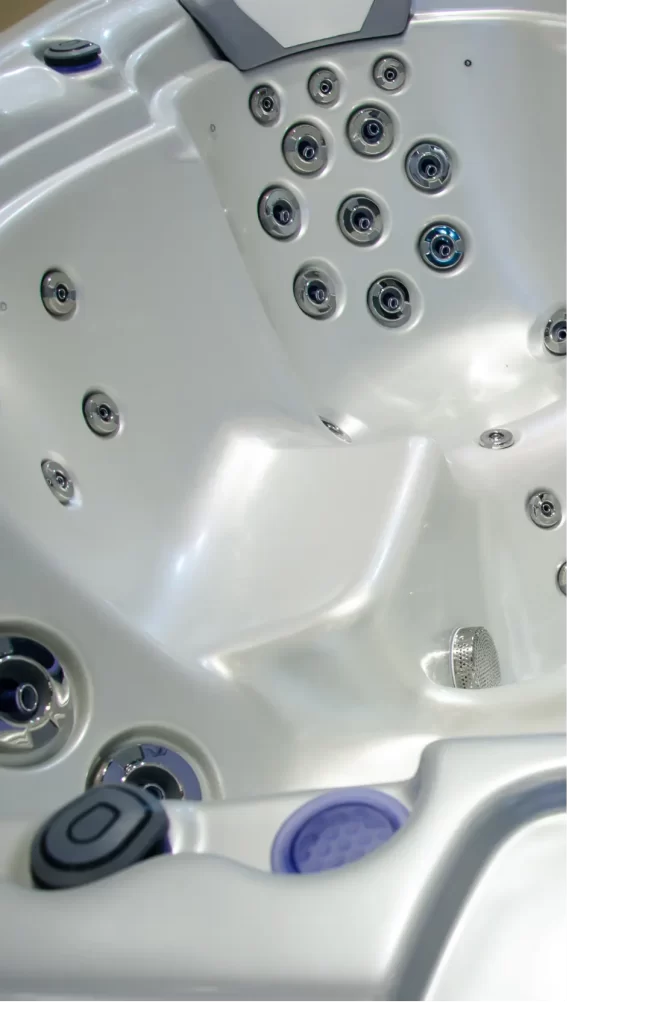 Photo of the interior of a hot tub without any water in it.