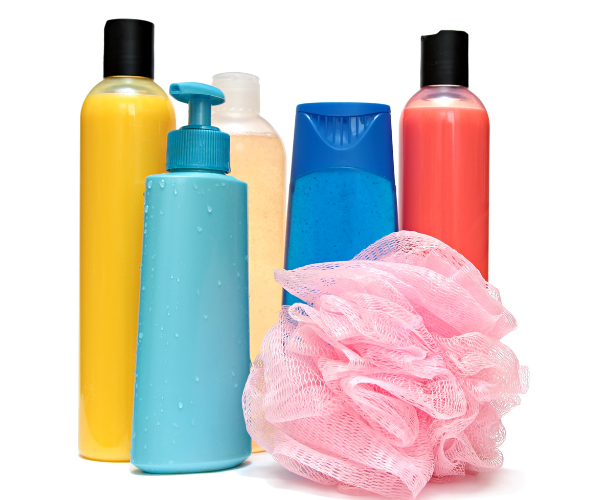 5 bottles of various personal care products in different colors. There is also a pink loofah in the photo.