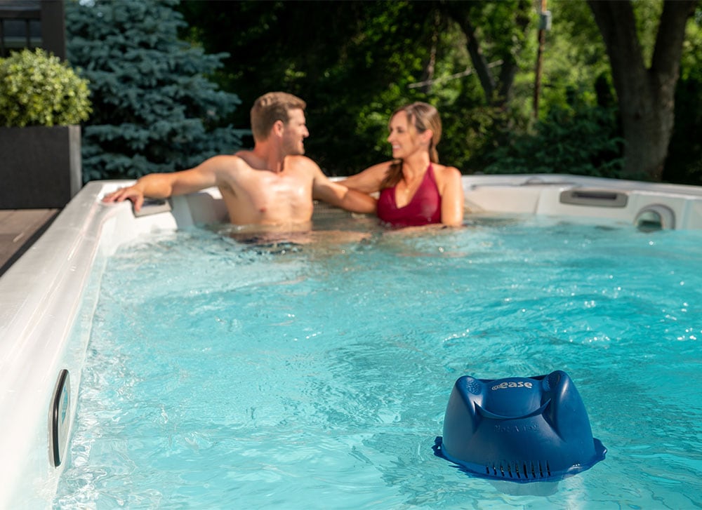 Swim Spa Family Fun — Crystal-Clear Water with FROG® @ease® System Family enjoying a FROG®-treated swim spa — mom, dad, and child using the swim spa.