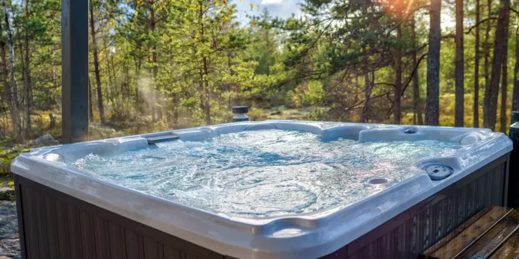 Hot Tub with the forest background. The sunlight is beaming down to the bubbles from the jets.