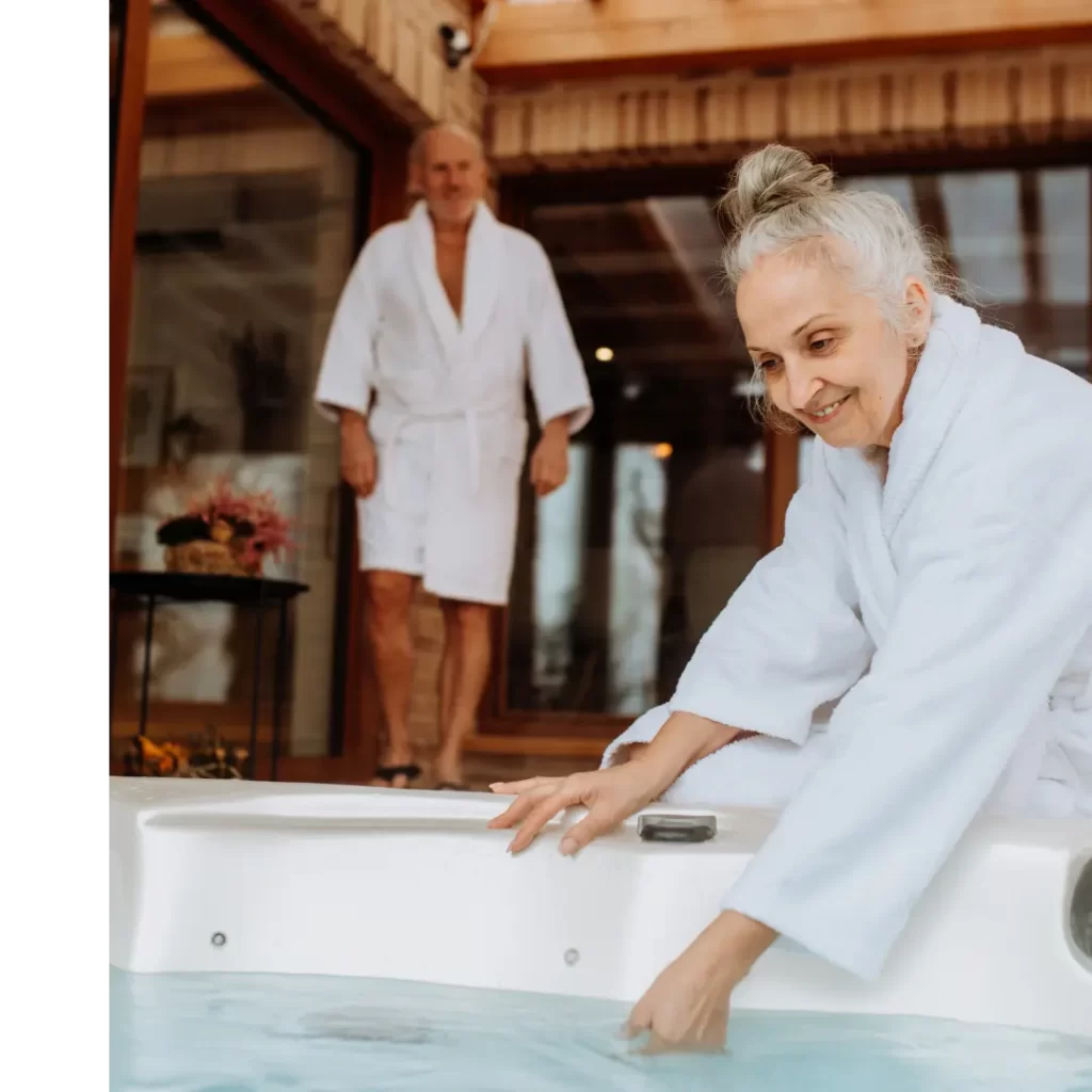 Female dipping her arm into the Hot Tub to ensure checking the temperature in the Hot Tub.