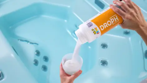 FROG® DropH® — Step 1: Adjust Alkalinity Before pH in Hot Tubs FROG® DropH® being poured into a TruDose™ cap over a hot tub — always adjust total alkalinity first using FROG® Target or DropH® before correcting pH.