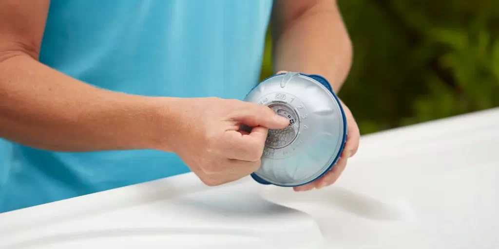 Woman attaching the SmartChlor® cartridge to the FROG @ease® System for easy chlorine control in her hot tub.